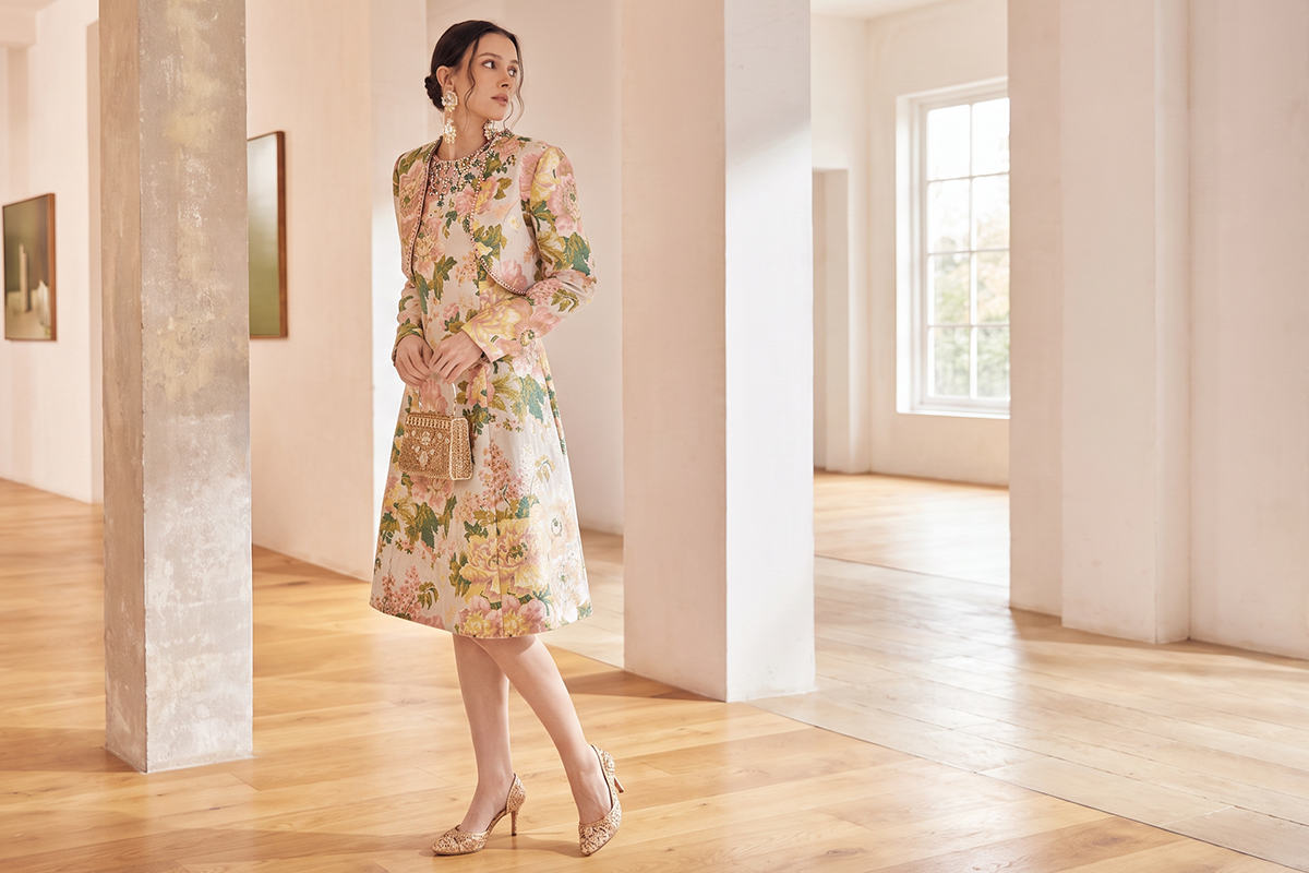 Woman in knee-length floral guest dress